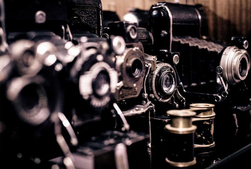 A shelf of cameras