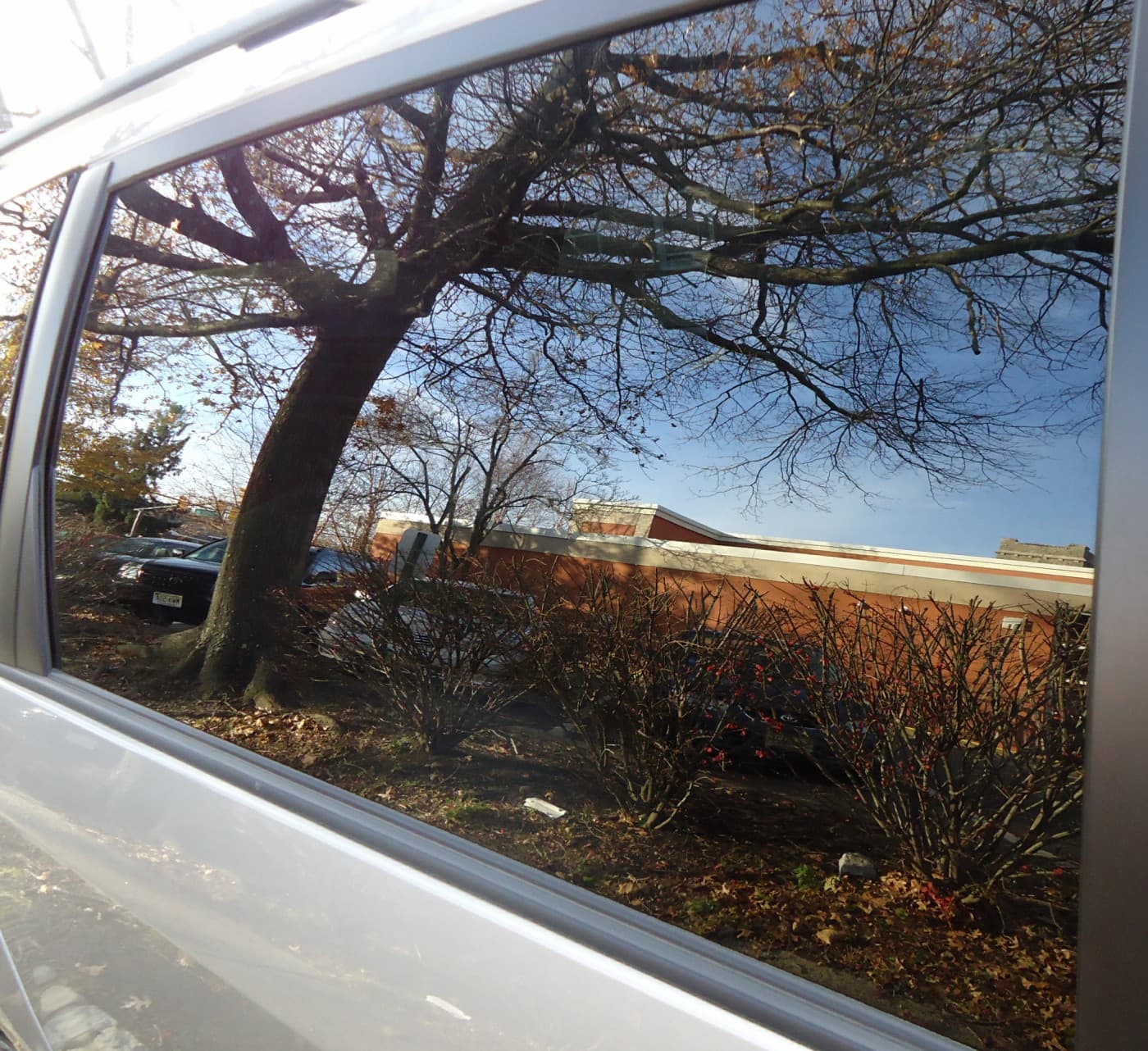 Reflection in car window glass Summit library in reflection