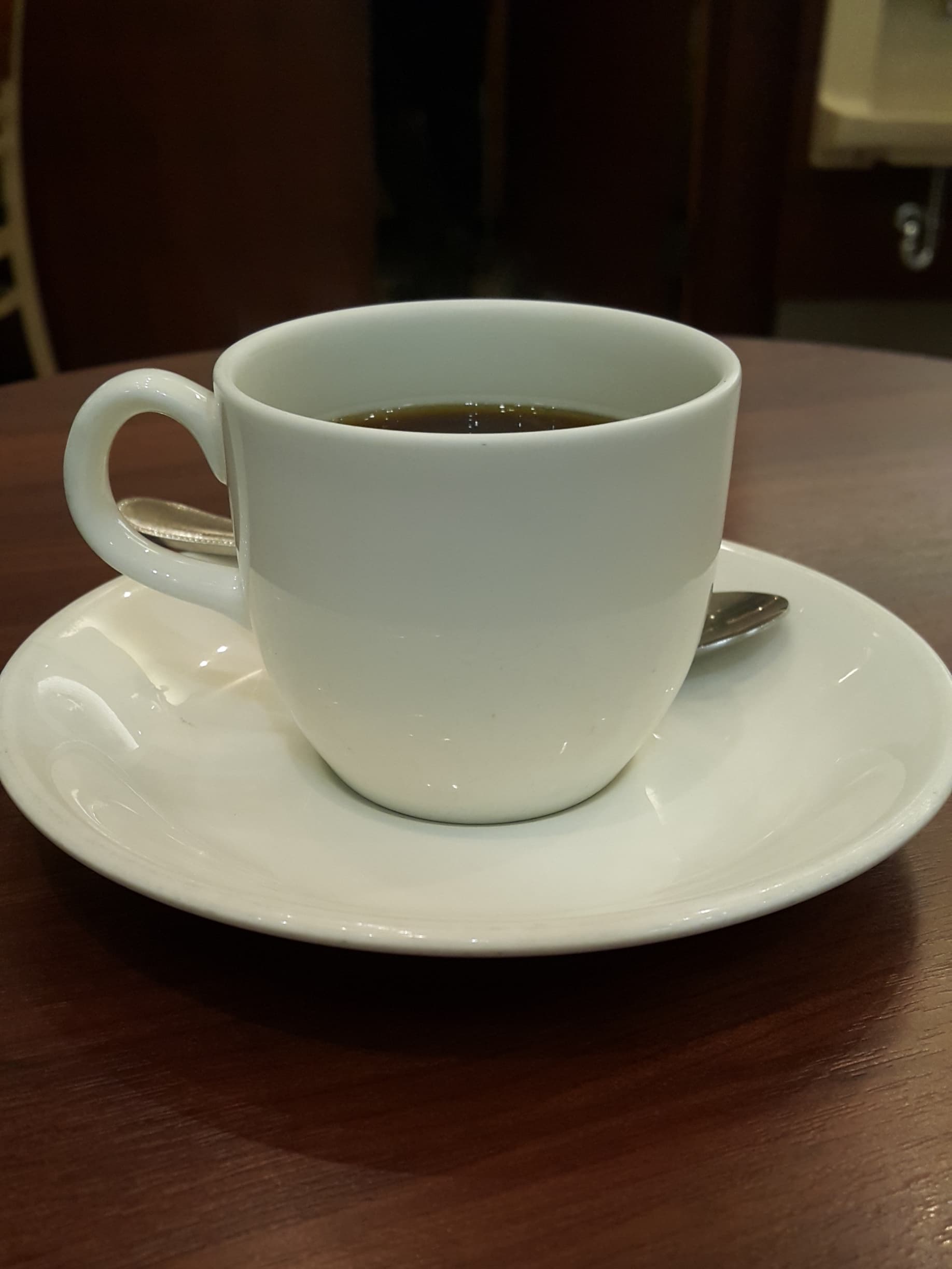 Coffee and white saucer