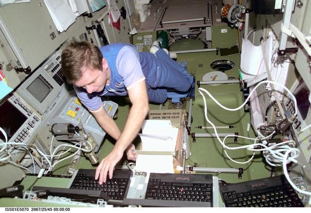 Gidzenko in Service Module with laptop computers