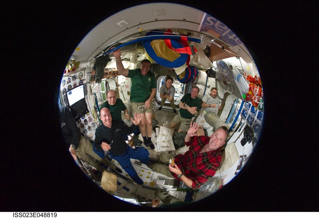 Fisheye View of Crewmembers Sharing a Meal in the SM