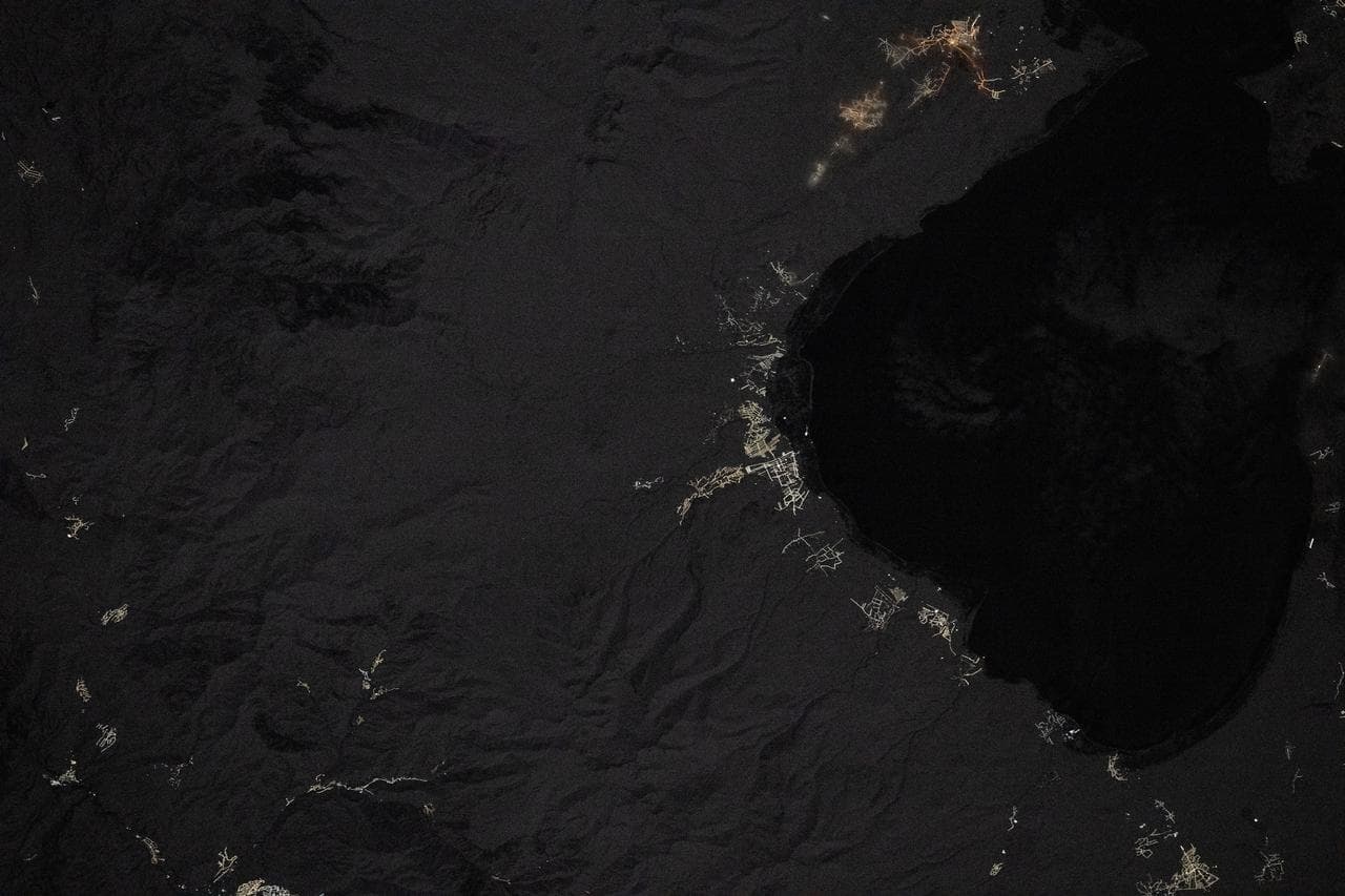 Villages light up the coastline in this nighttime image of Lake Sevan