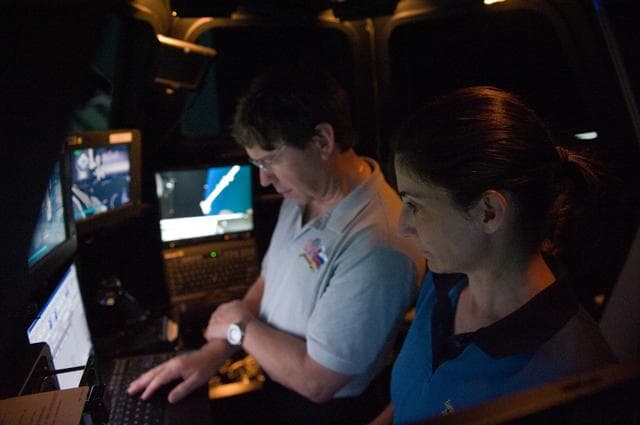 STS-133 crew members Mike Barratt and Nicole Stott in cupola