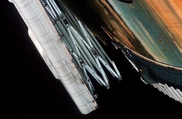 Close-up view of partially deployed, damaged solar array