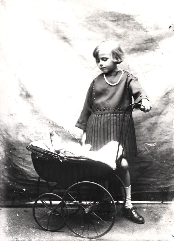 059336:Studio portrait of a girl with a doll's pram Unknown c.1925