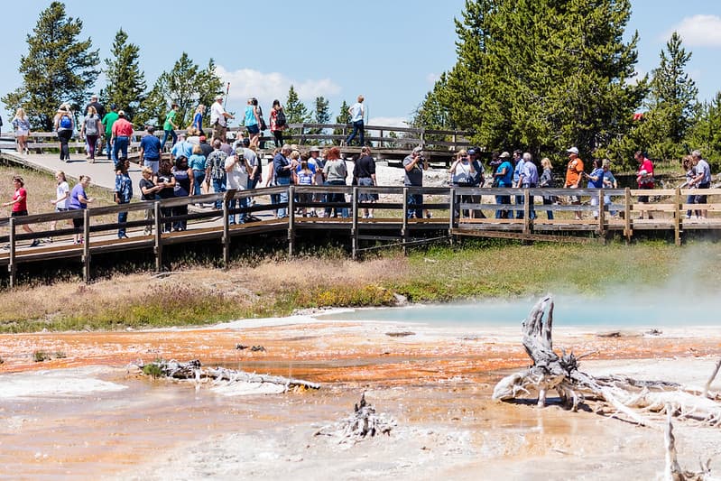 Group of people photographing Silex spring from the boardwalk