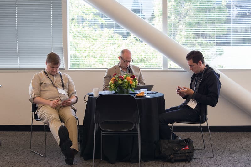 SVVR attendees seated at table and using electronics