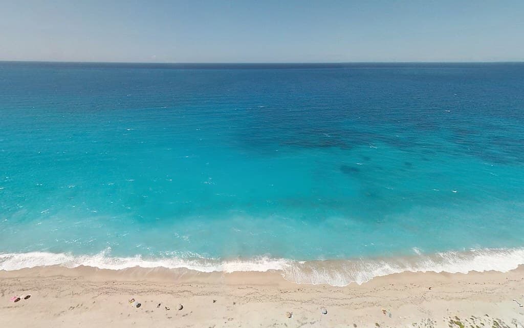 Turquoise Ocean Water by Beach