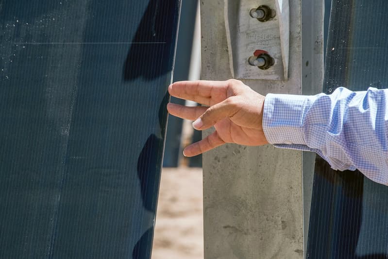 A hand touches a solar panel