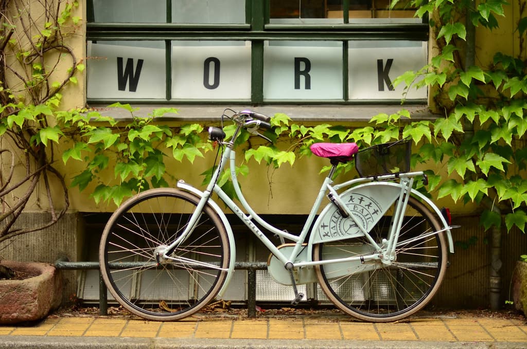 Bicycle Outside Window with Work Sign
