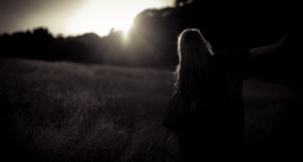 Female Silhouette in Field with Sunlight